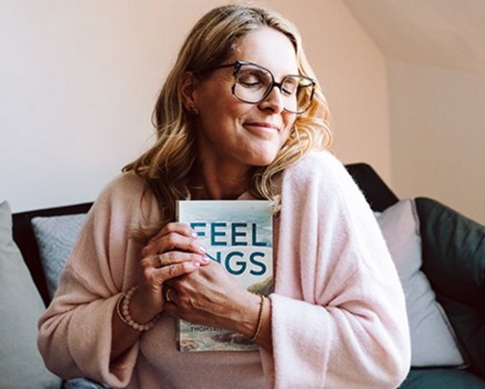 women is holding her book
